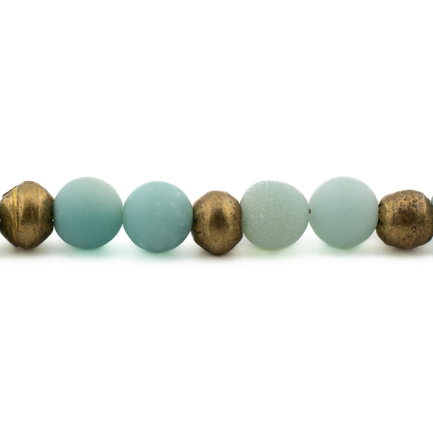 Close-up of polished amazonite gemstone beads in aqua-green tones, handmade yoga bracelet from Texas.