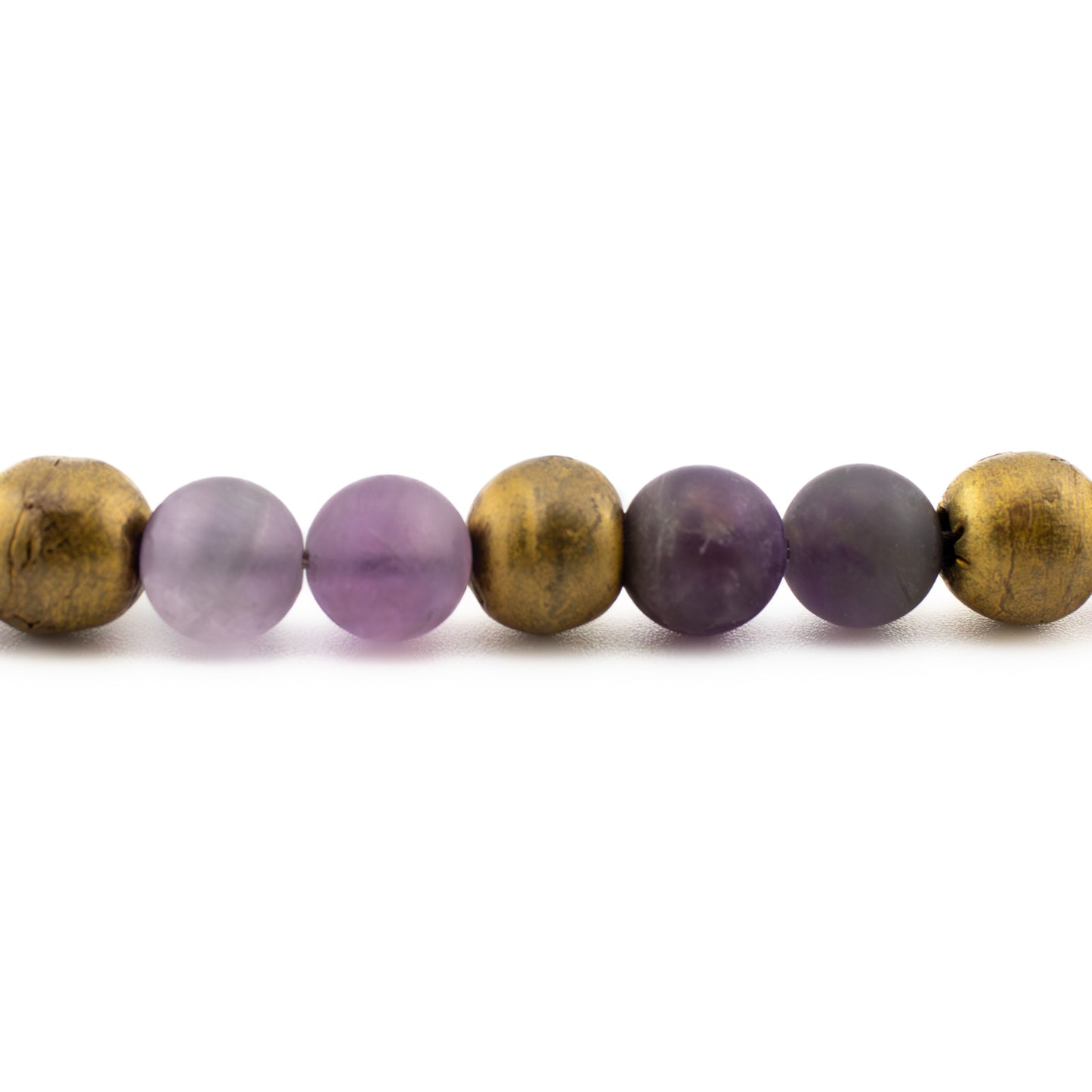 Close-up of amethyst beads with medium to deep purple tones, handmade yoga bracelet from Texas.