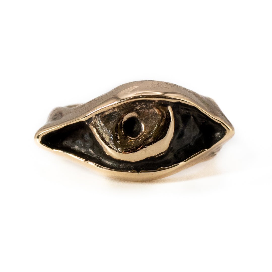 Close-up of cast bronze Evil Eye ring showing artisan texture and craftsmanship
