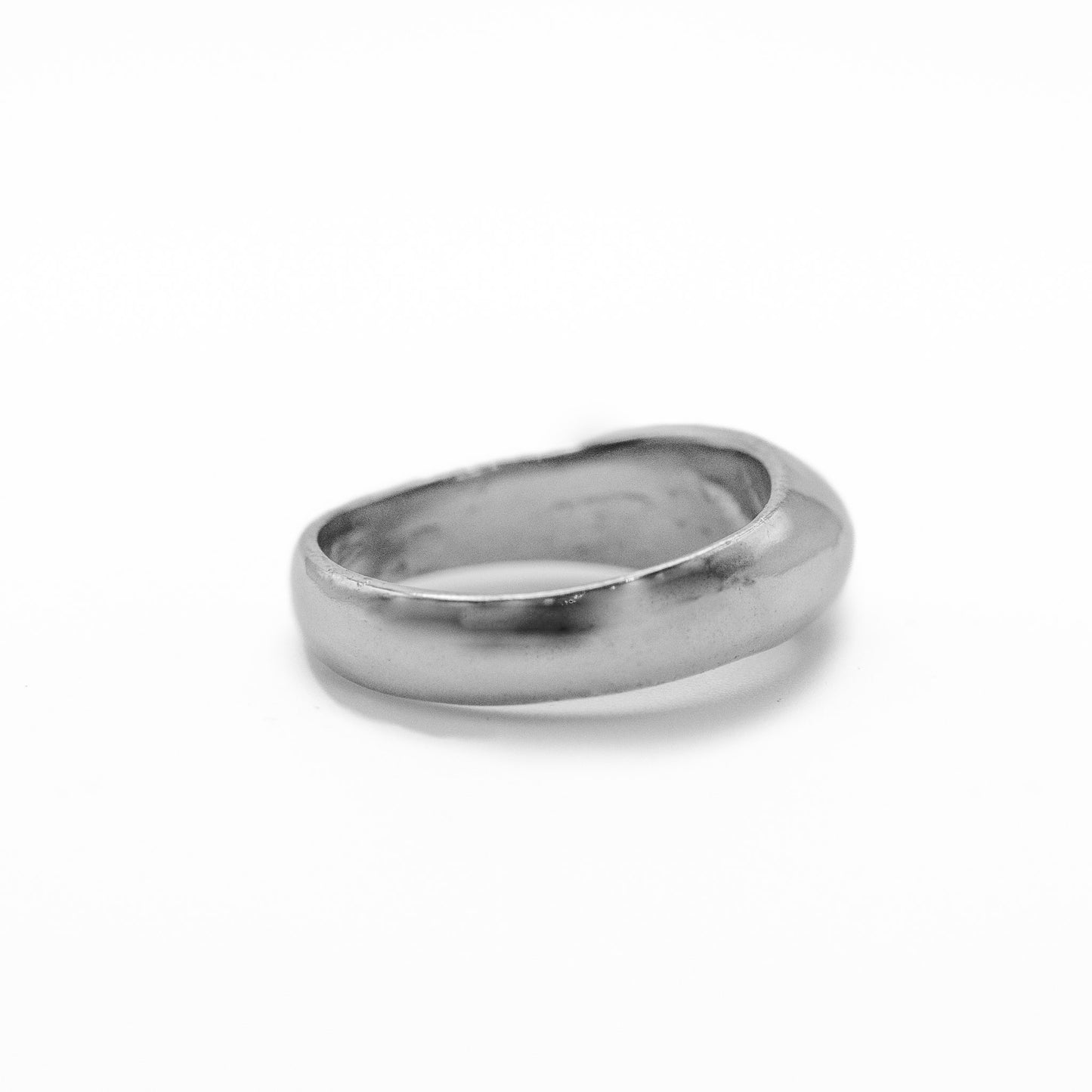 Cast sterling silver dome ring side back view showing curved band and polished finish