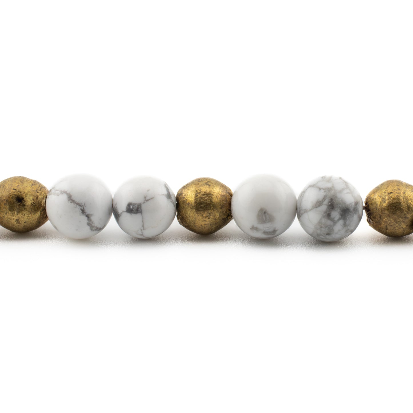 Close-up of polished Howlite beads with gray veining, stress relief and meditation bracelet handmade in Austin.