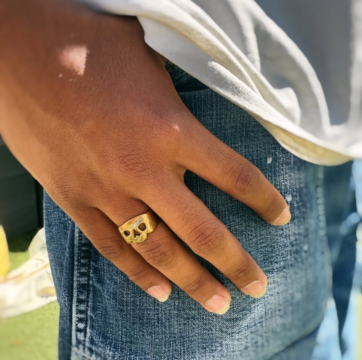 Maxilla Skull Ring in solid bronze worn as a men’s pinky ring on male hand model, handmade in Austin, Texas, USA