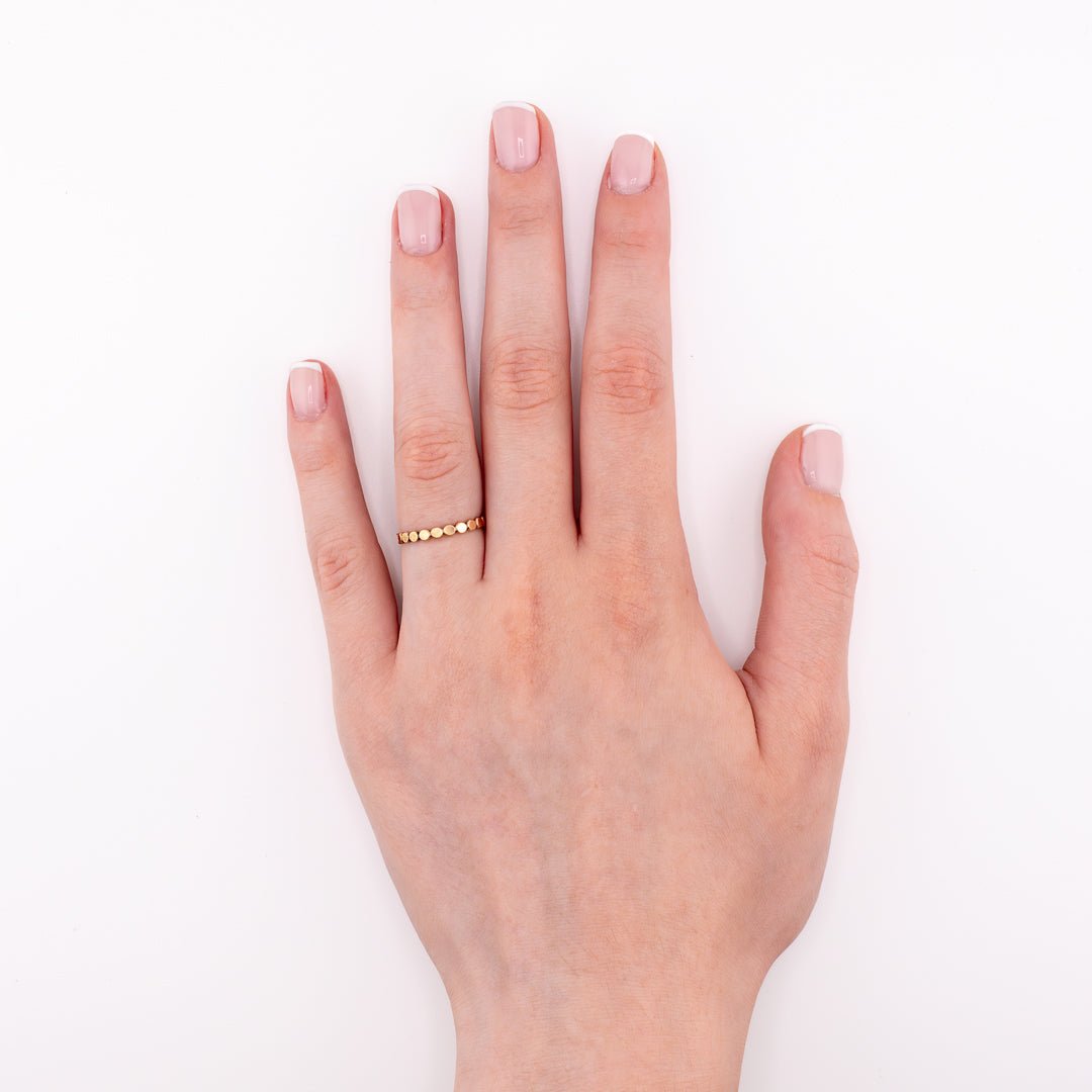 14k gold-filled Tiny Bubbles stacking ring on hand model, minimalist dainty jewelry for layering