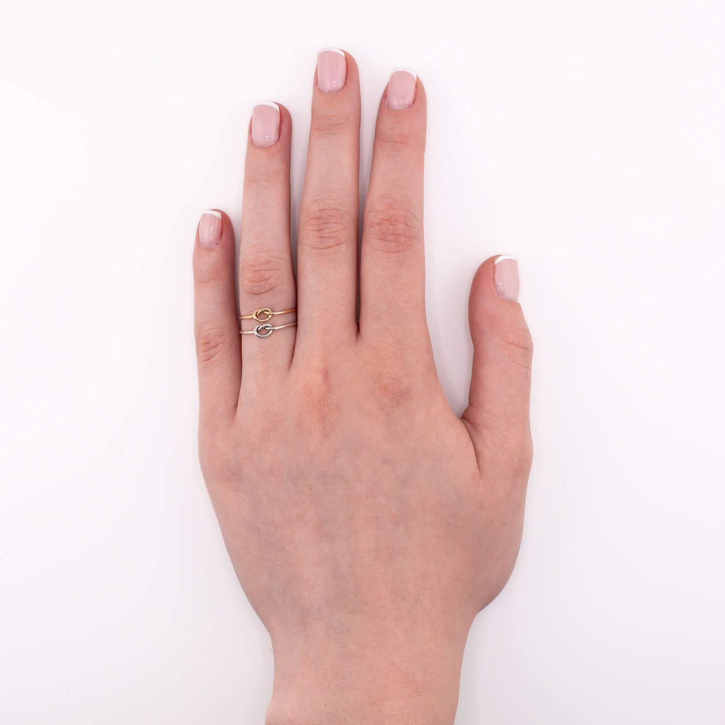 Tiny Knot stacking ring layered with sterling silver and 14k gold-filled bands, minimalist knot jewelry for everyday wear