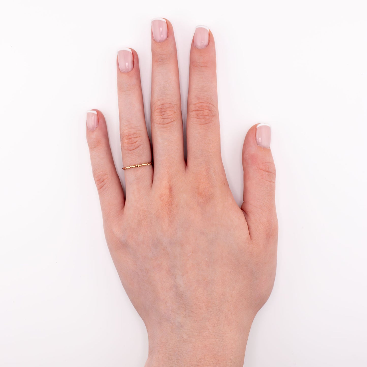 14k gold-filled Tiny Twist stacking ring on hand model, delicate twisted jewelry for everyday stacking