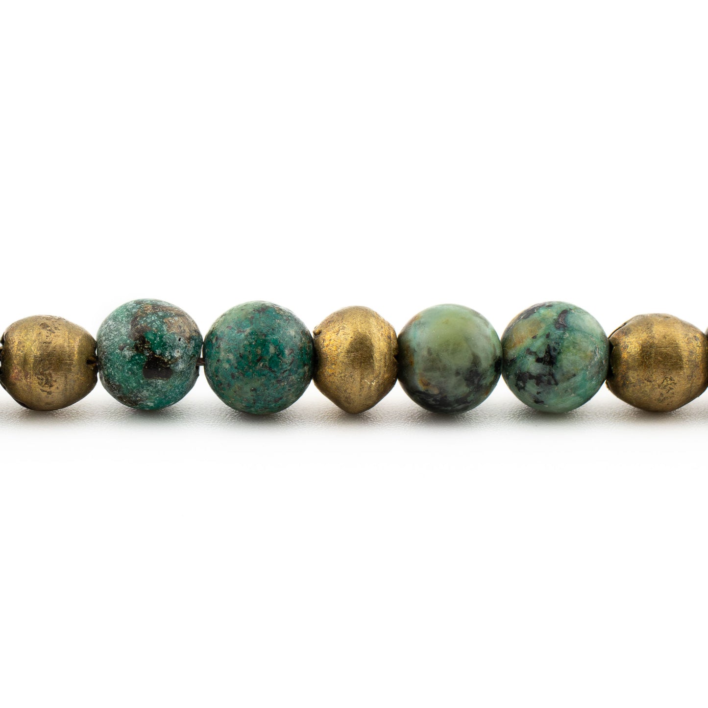 Close-up of polished turquoise beads with natural veining, protective meditation bracelet handmade in Austin.