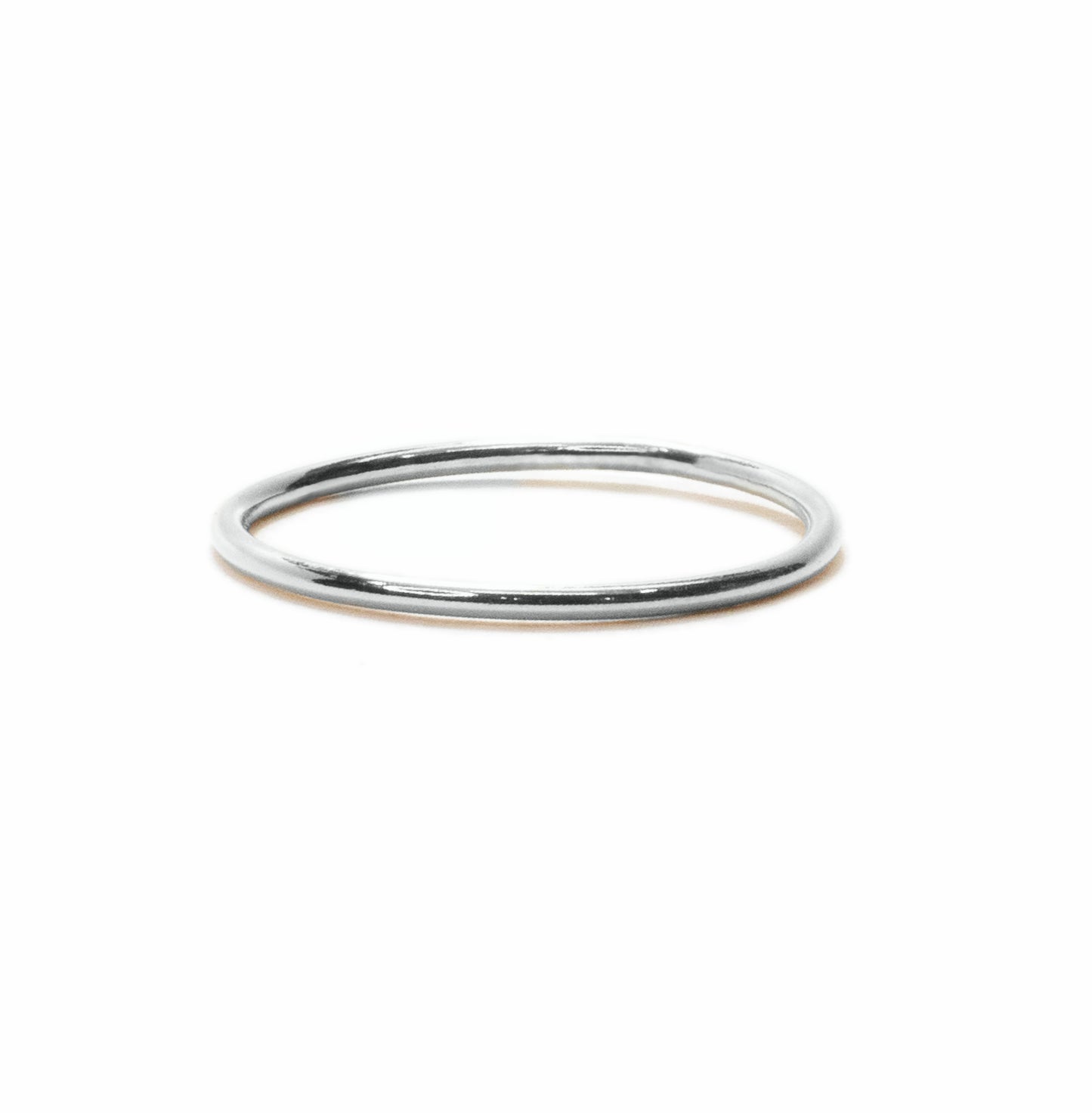 Tiny band sterling silver stacking ring handmade on a white background front