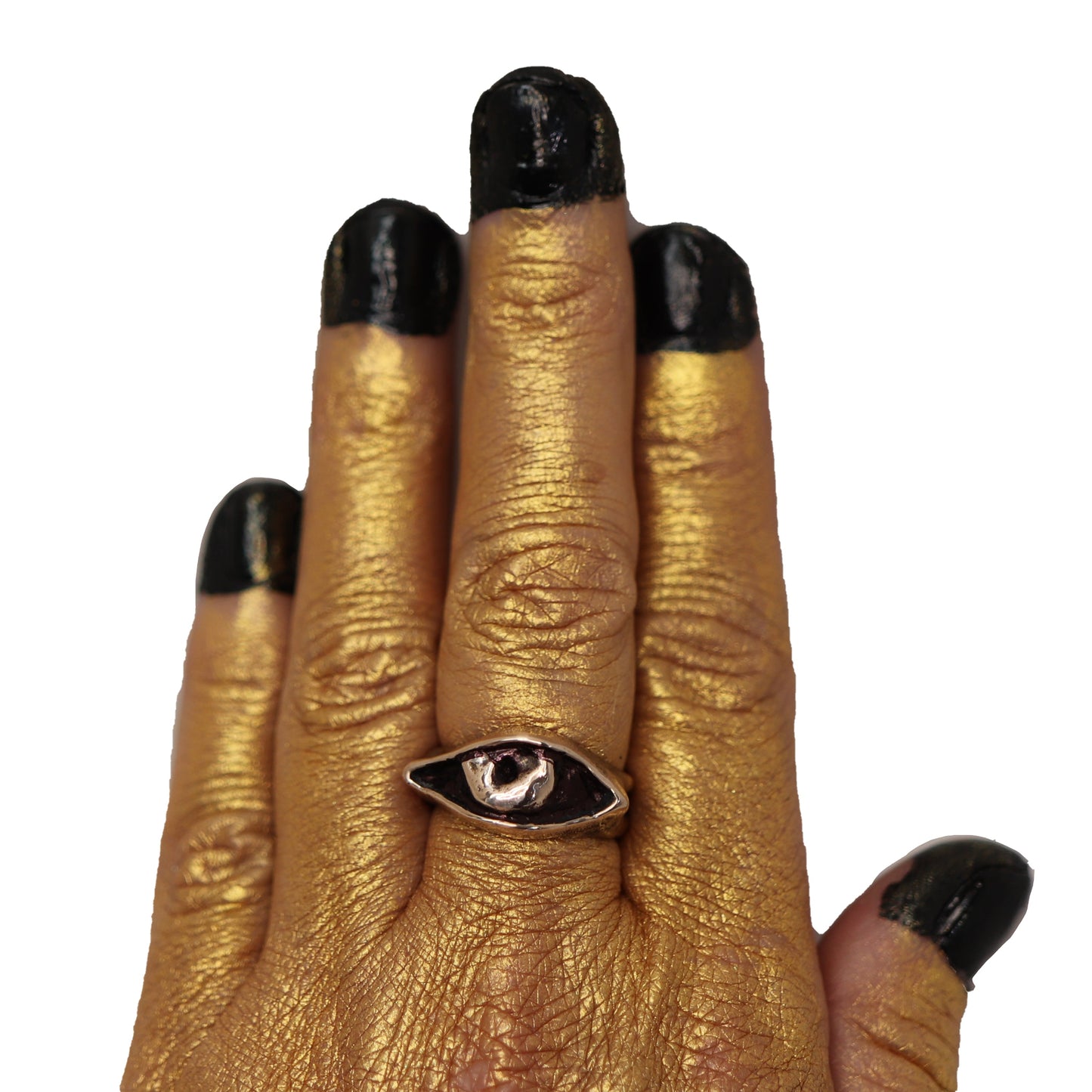 Hand model with gold-toned skin wearing cast bronze Evil Eye ring, symbolic handmade jewelry