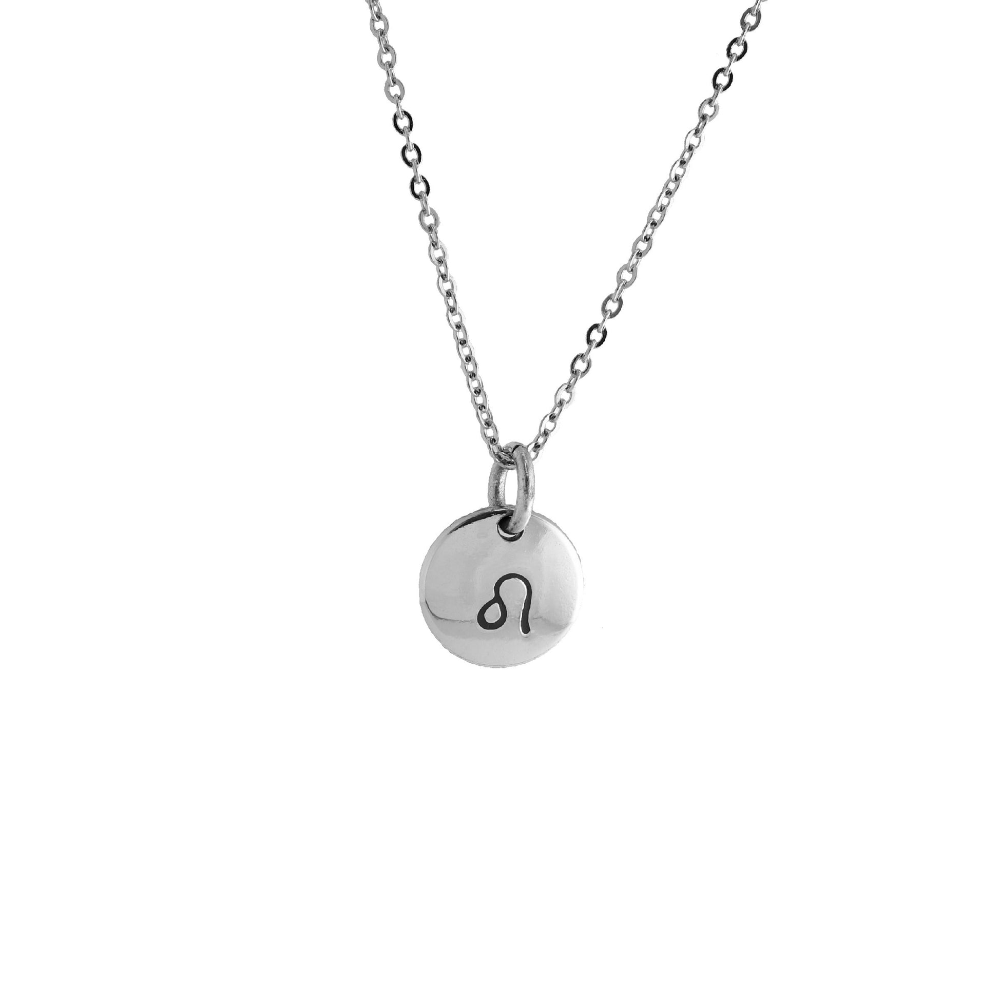 A silver circular pendant necklace with a stamped symbol on it, representing the Leo zodiac sign.