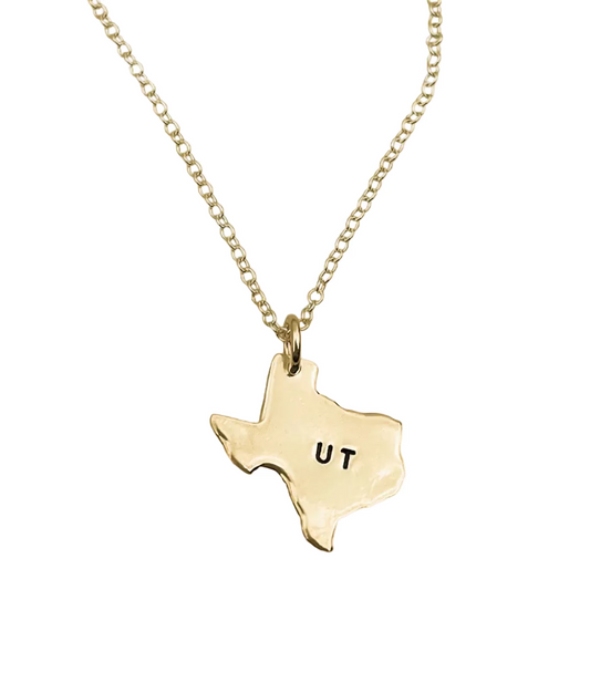 Gold necklace with a Texas-shaped pendant displaying 'UT' on a white background