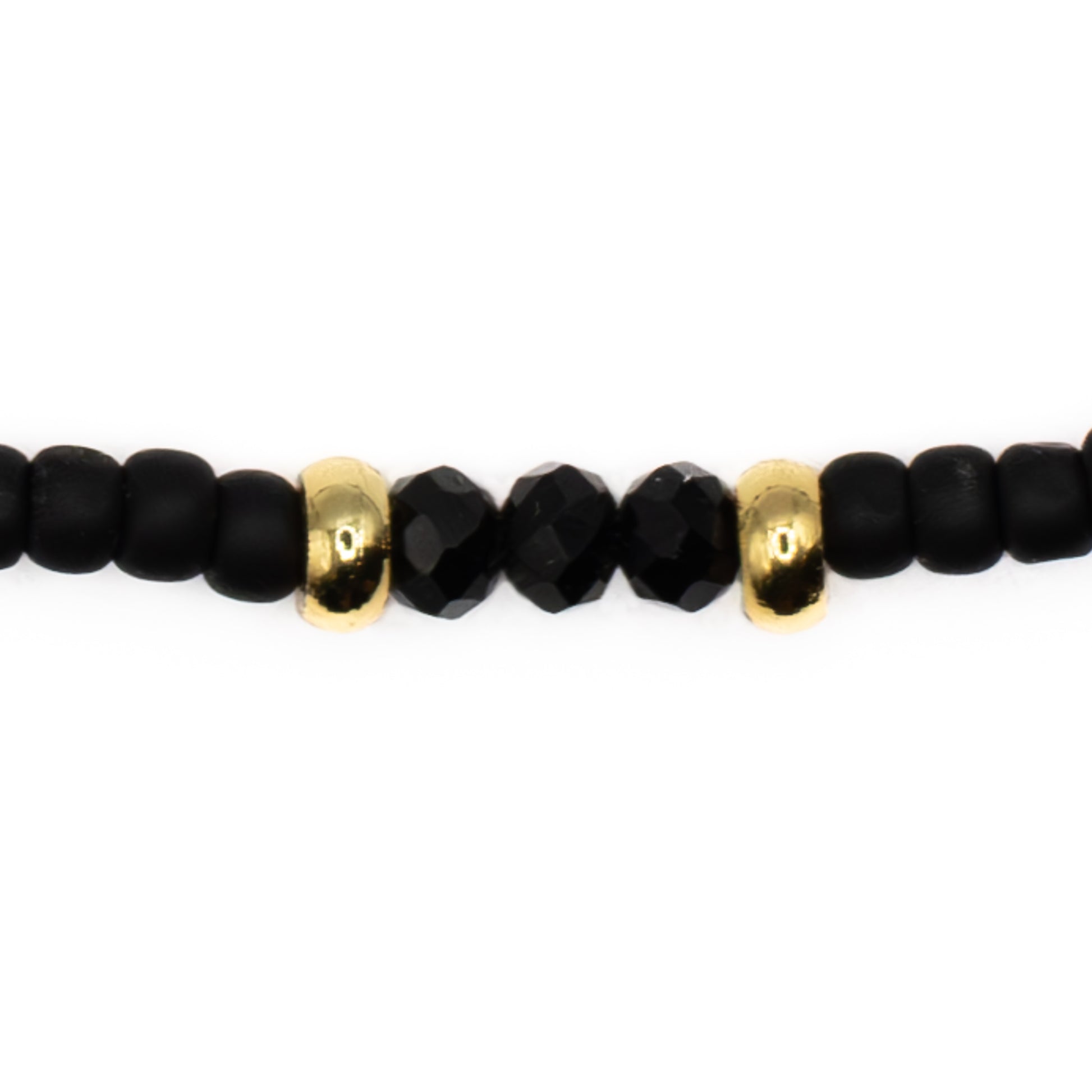 Close up detail of Black Seed Bead Anklet, durable black glass beads with gold accents on strong elastic