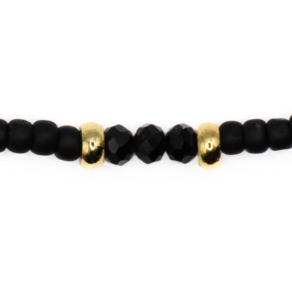 Close up detail of Black Seed Bead Anklet, durable black glass beads with gold accents on strong elastic