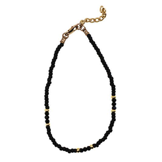 Overhead view of handmade Black Seed Bead Anklet with black glass beads and gold accents, jewelry made in Austin Texas