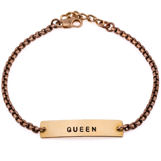 Bronze stacking bracelet stamped with Queen, women’s handmade jewelry on a white background