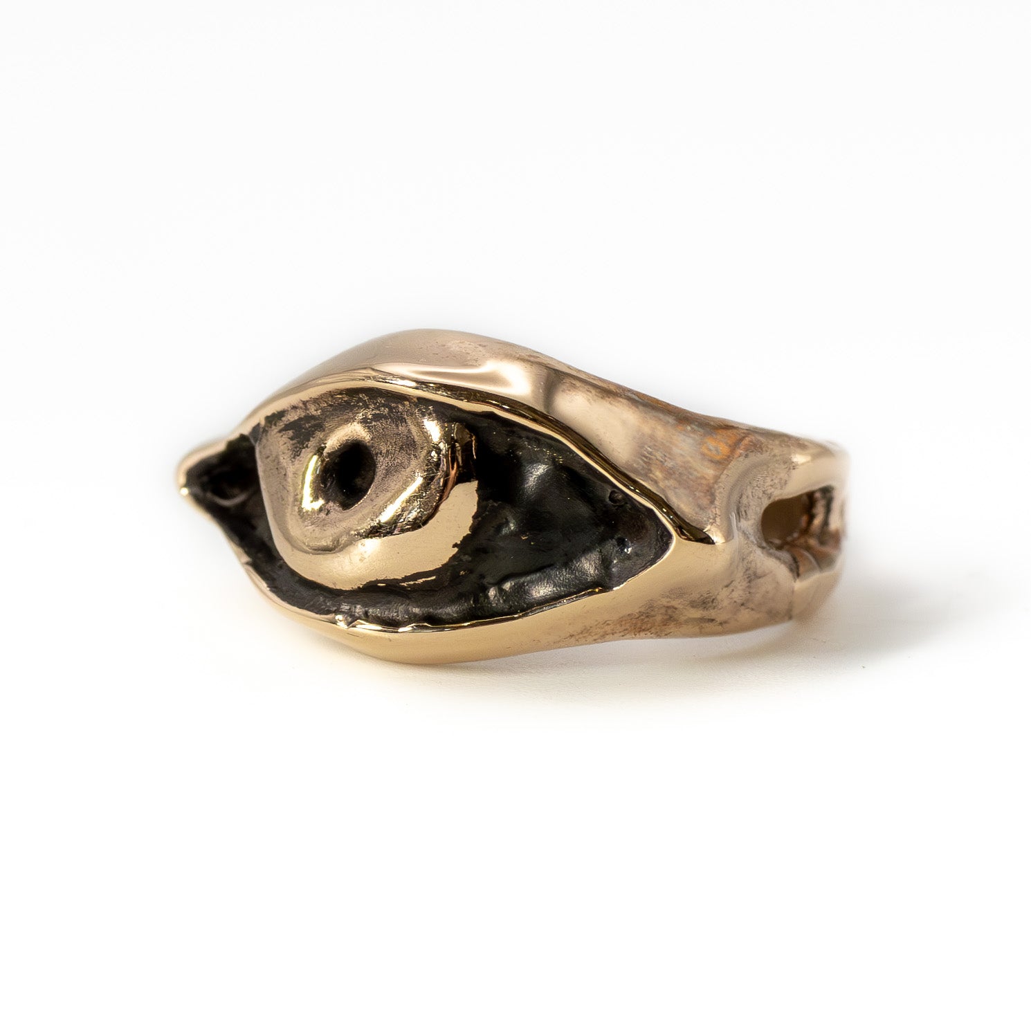 Cast bronze Evil Eye ring photographed at an angle, handmade talisman jewelry from Austin, Texas 2