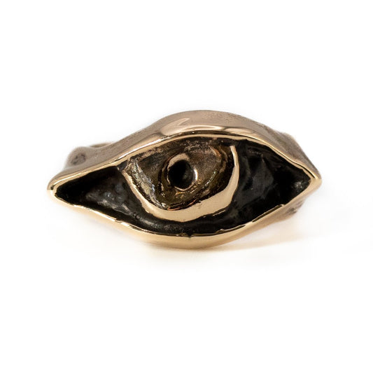 Close-up of cast bronze Evil Eye ring showing artisan texture and craftsmanship