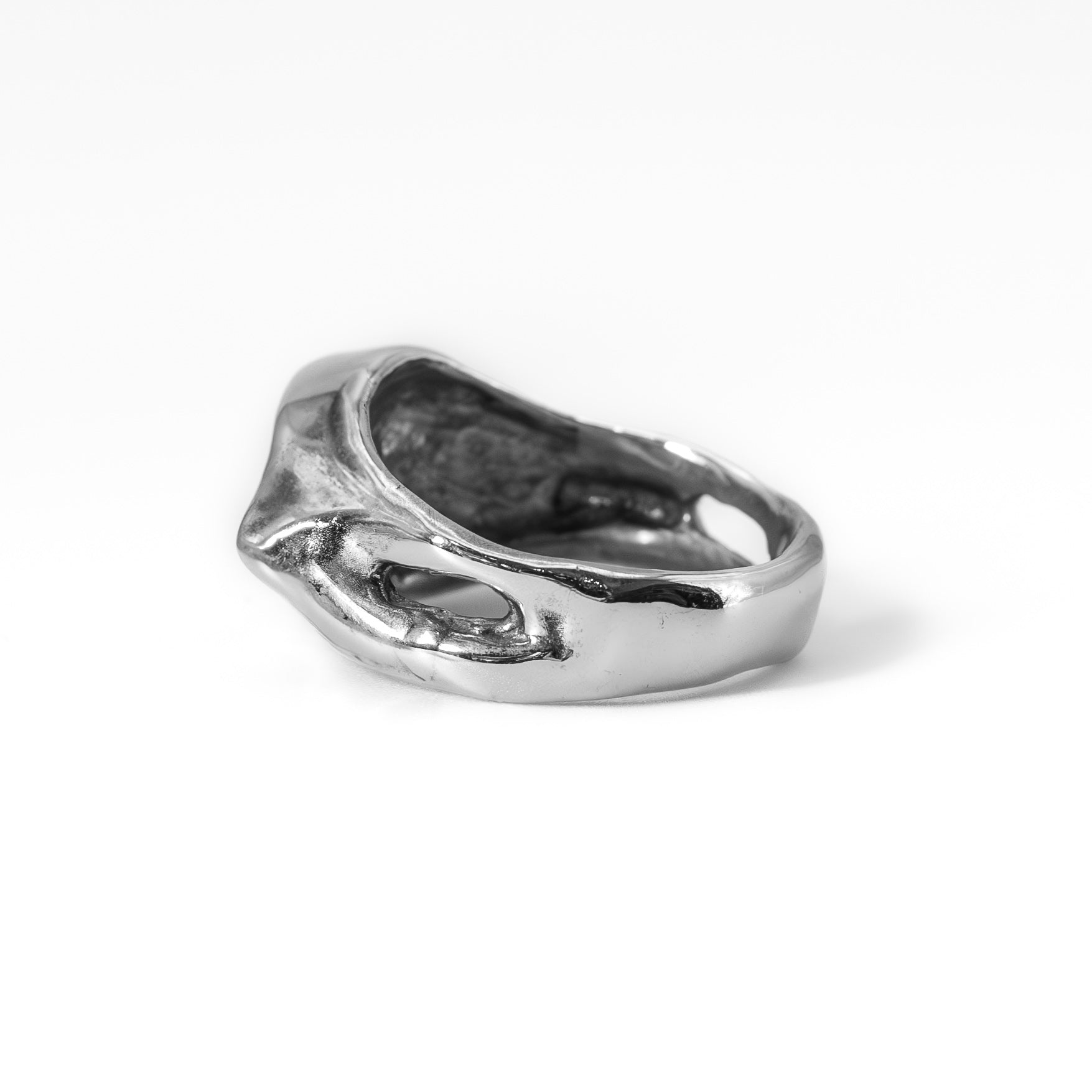 Cast silver Evil Eye ring photographed at an angle, handmade protective talisman jewelry