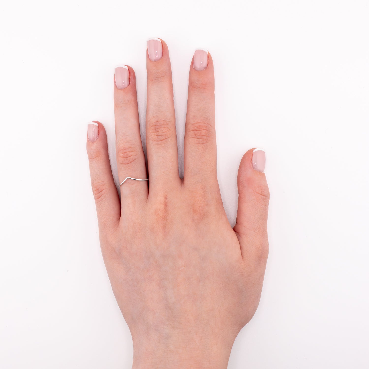 Sterling silver chevron stacking ring on hand model, delicate V-shaped minimalist jewelry