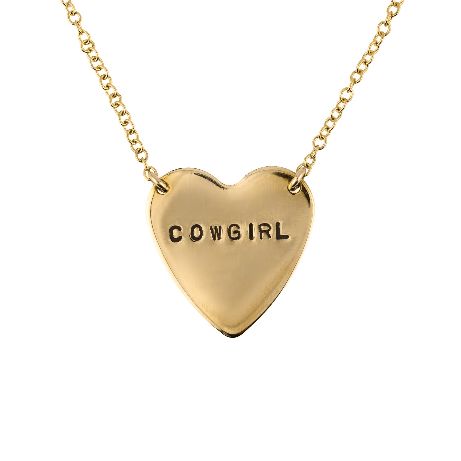 Gold heart-shaped necklace with 'COWGIRL' stamped on a white background