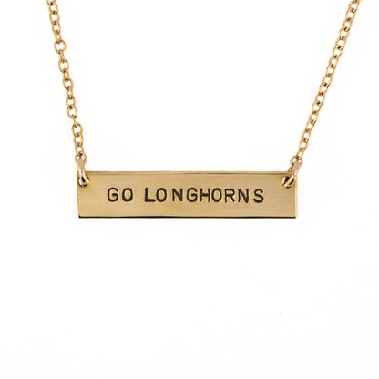 Gold necklace with 'GO LONGHORNS' pendant on a white background
