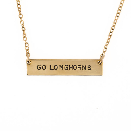 Gold necklace with 'GO LONGHORNS' pendant on a white background