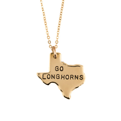 Gold necklace with a Texas-shaped pendant that says 'GO LONGHORNS' on a white background