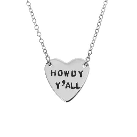 Heart-shaped silver necklace with 'HOWDY Y'ALL' engraving on a white background