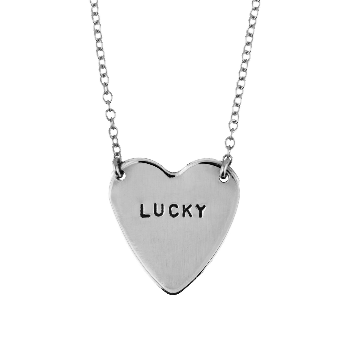 Silver heart-shaped pendant with 'LUCKY' engraving on a chain against a white background