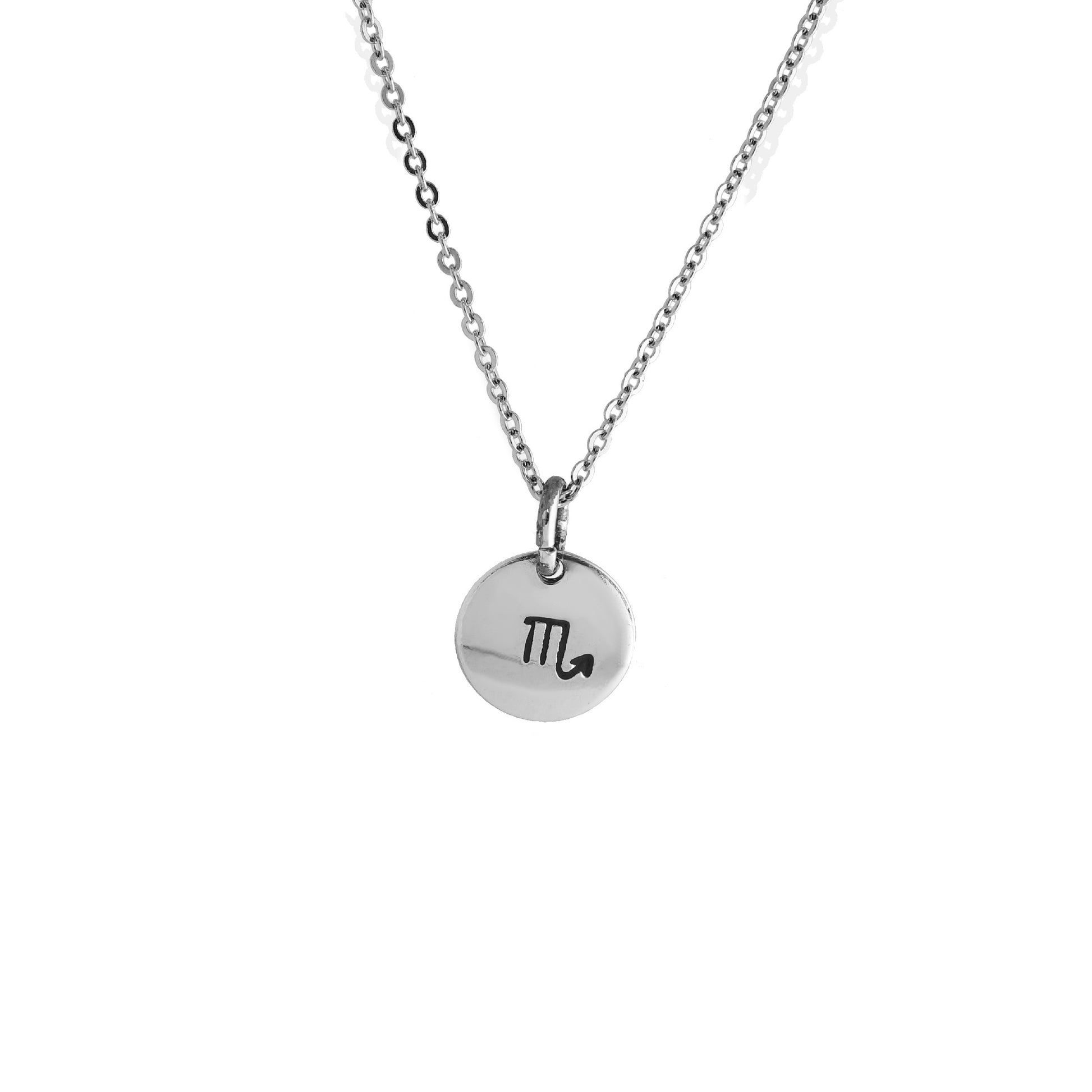 A silver necklace with a circular charm featuring the symbol for Scorpio, the zodiac sign.