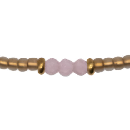 Close up of handmade Tan Gold and Light Pink Seed Bead Anklet, durable glass beads in light pink and soft tan gold with gold accents, made in Austin TX