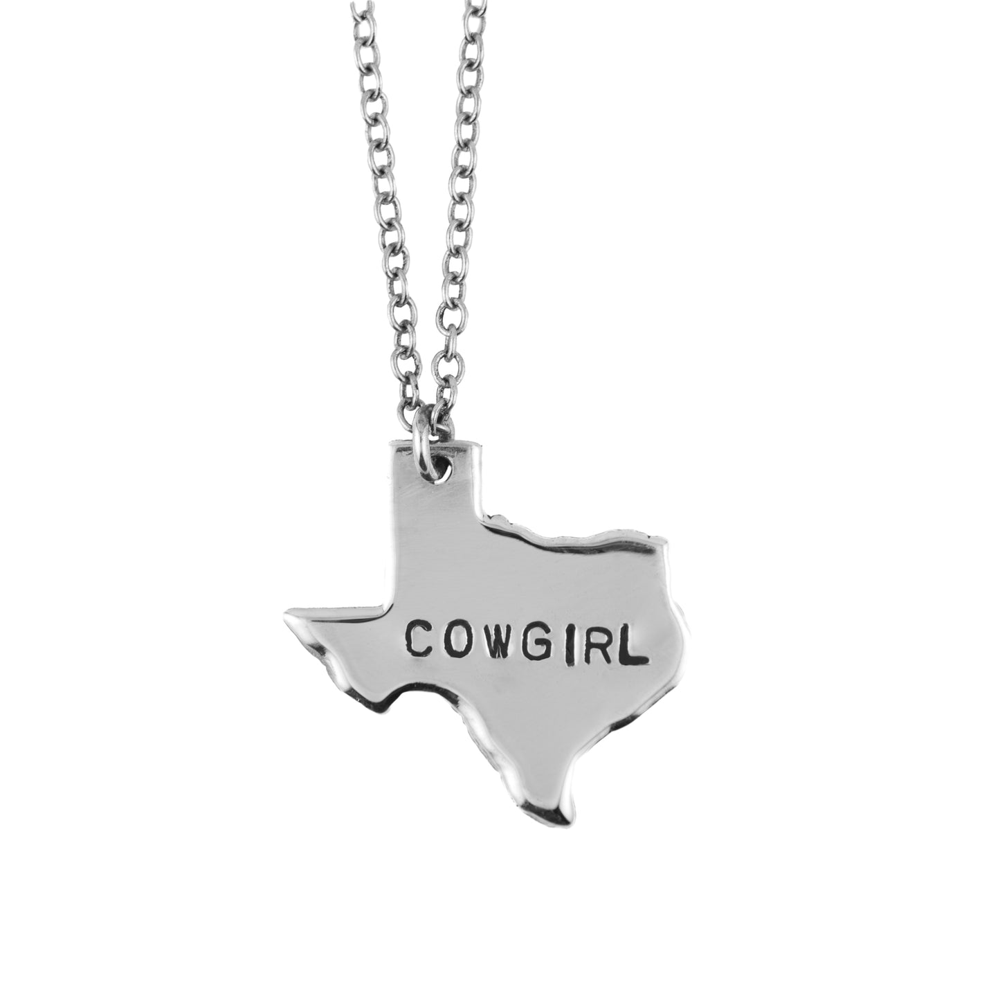 Silver necklace with a Texas-shaped pendant that reads 'COWGIRL' on a white background