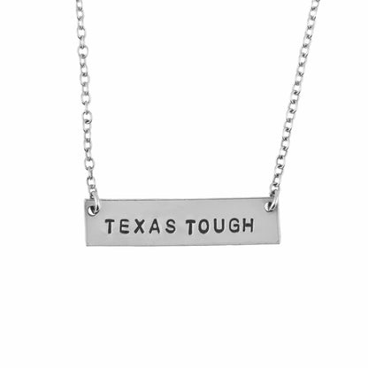 Silver necklace with 'TEXAS TOUGH' pendant on a white background