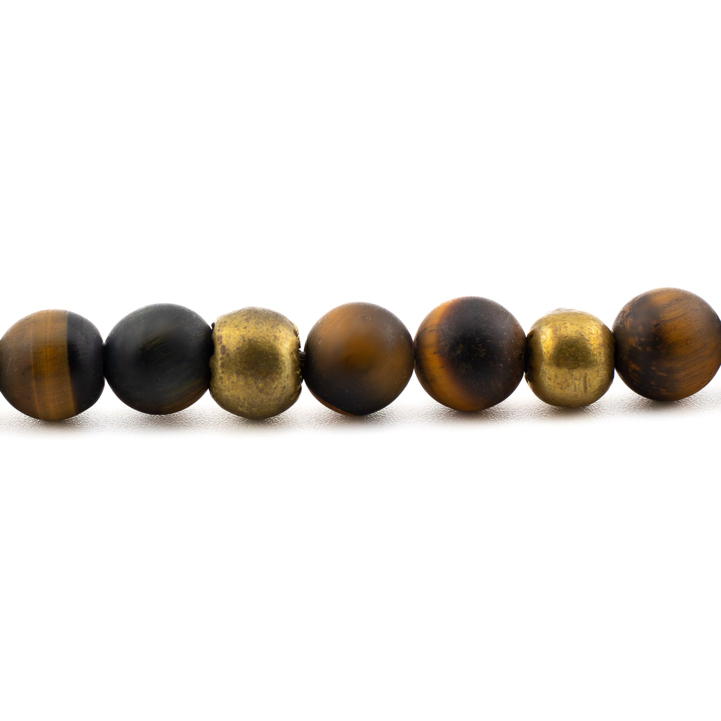 Close-up of golden-brown tiger’s eye gemstone beads, handmade yoga bracelet from Texas.
