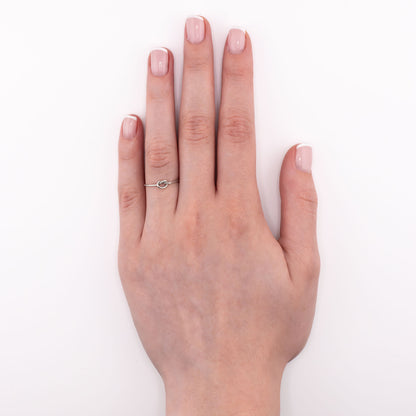 Sterling silver Tiny Knot stacking ring worn on hand, simple minimalist knot band for midi, pinky, or thumb styling
