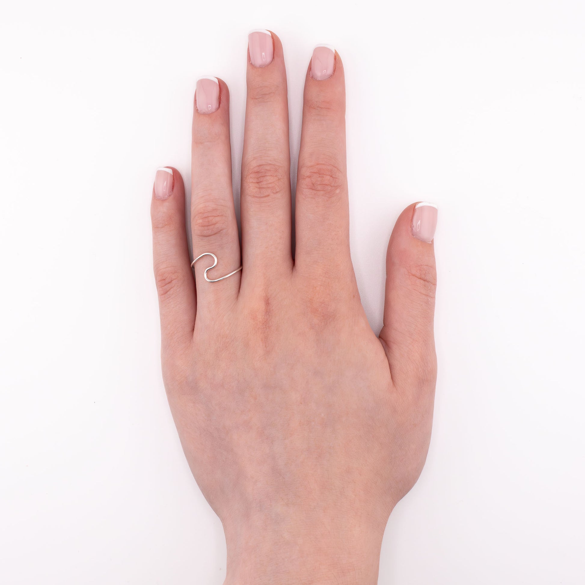 Sterling silver Wave stacking ring worn on hand, handmade ocean-inspired minimalist jewelry for everyday wear